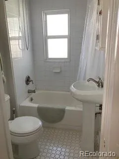 a bathroom with a sink a toilet and bathtub