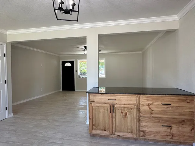 a view of an empty room and window with wooden floor