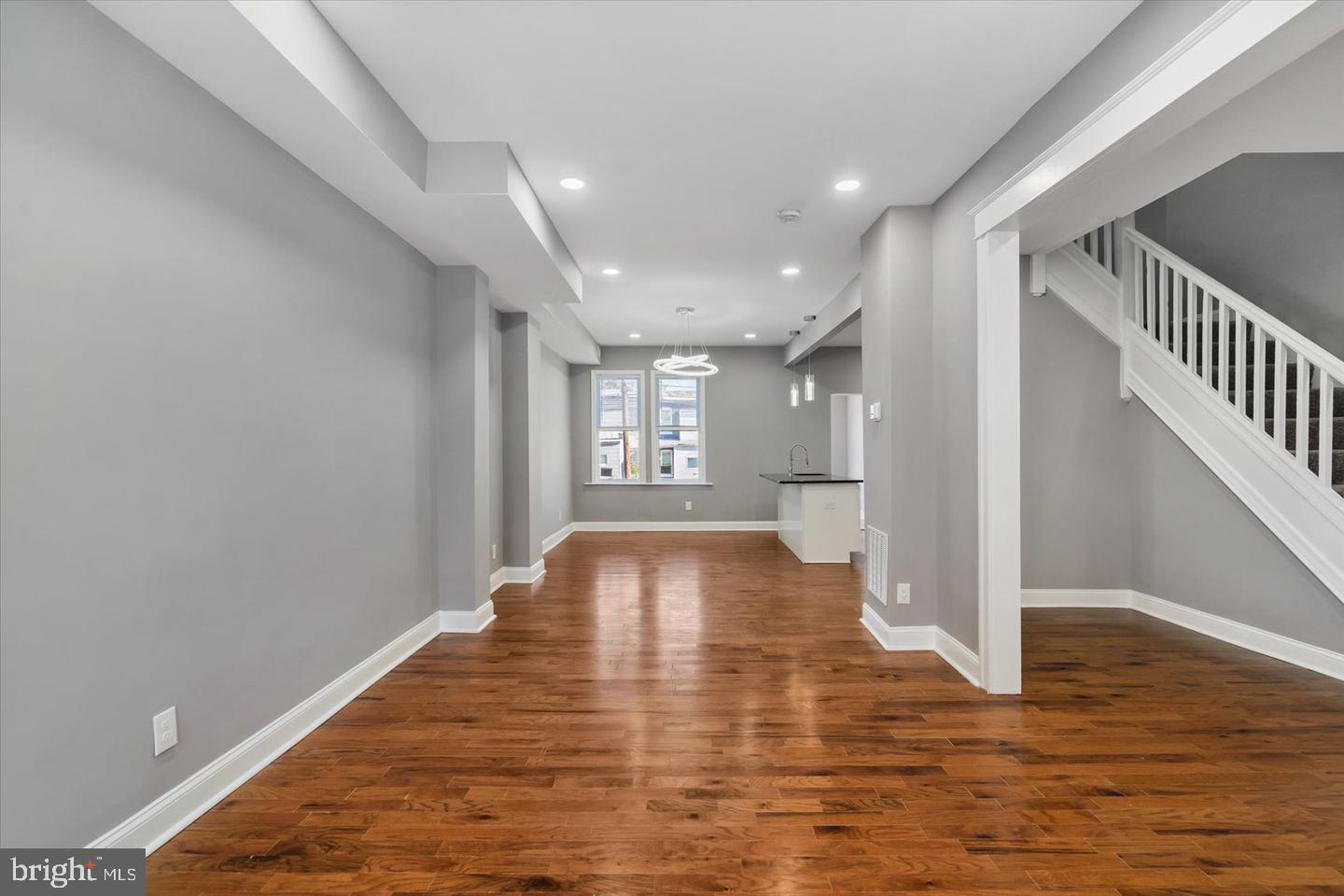 327 Lyndhurst Street Baltimore, MD 21229 - Photo 12 of 44 a view of an empty room with wooden floor and a window