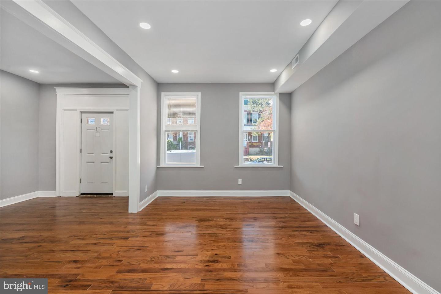 327 Lyndhurst Street Baltimore, MD 21229 - Photo 14 of 44 a view of an empty room with wooden floor and a window
