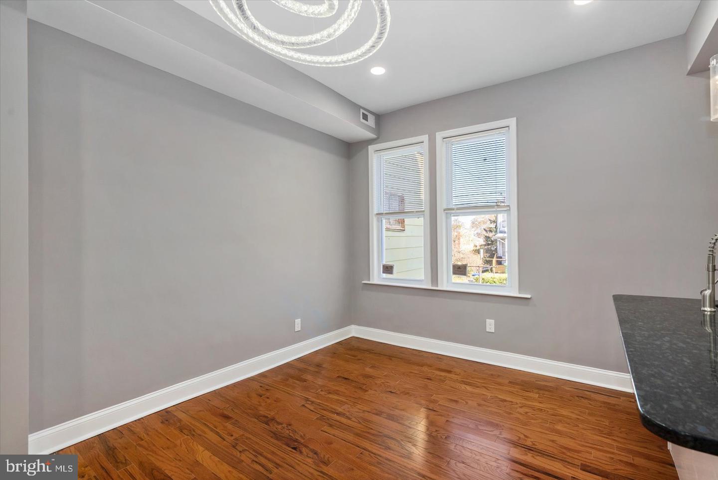 327 Lyndhurst Street Baltimore, MD 21229 - Photo 16 of 44 a view of an empty room with wooden floor and a window
