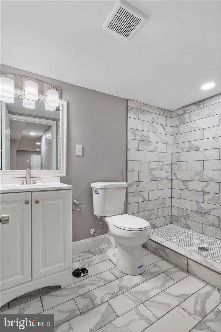 327 Lyndhurst Street Baltimore, MD 21229 - Photo 36 of 44 a bathroom with a toilet a sink and mirror