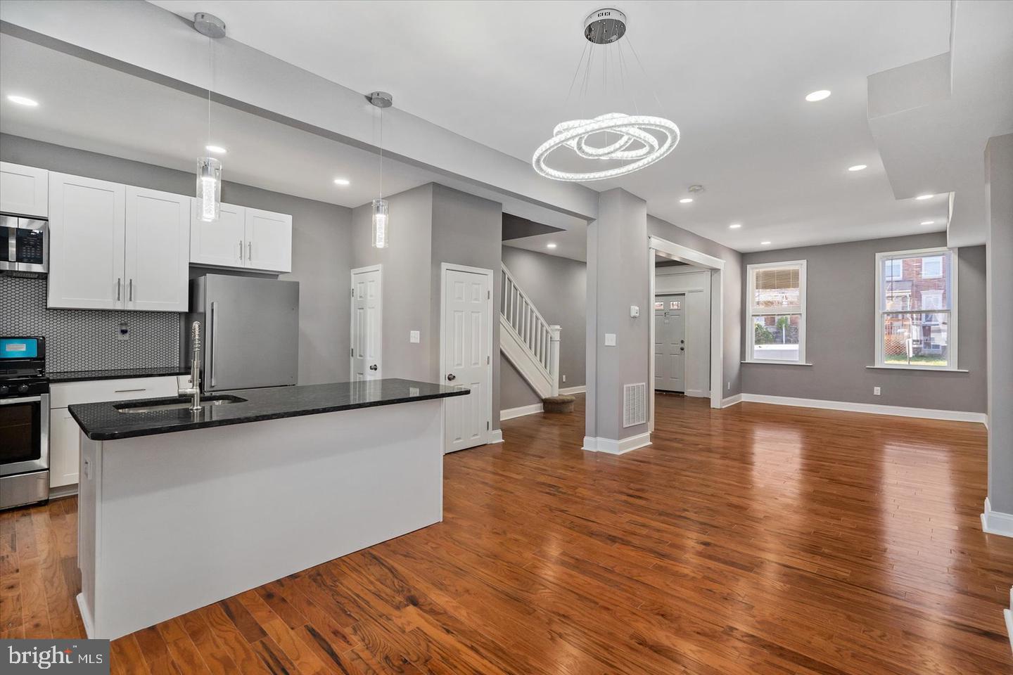 327 Lyndhurst Street Baltimore, MD 21229 - Photo 4 of 44 a large kitchen with stainless steel appliances granite countertop a lot of counter space and wooden floor