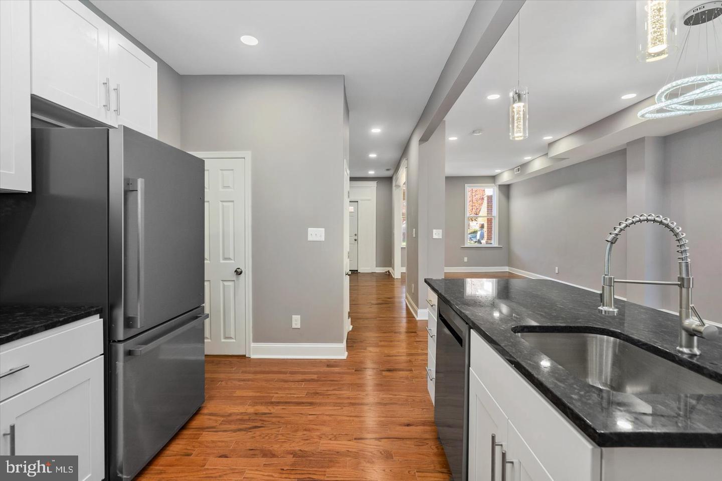 327 Lyndhurst Street Baltimore, MD 21229 - Photo 7 of 44 a kitchen with stainless steel appliances granite countertop a sink a refrigerator and a granite counter tops