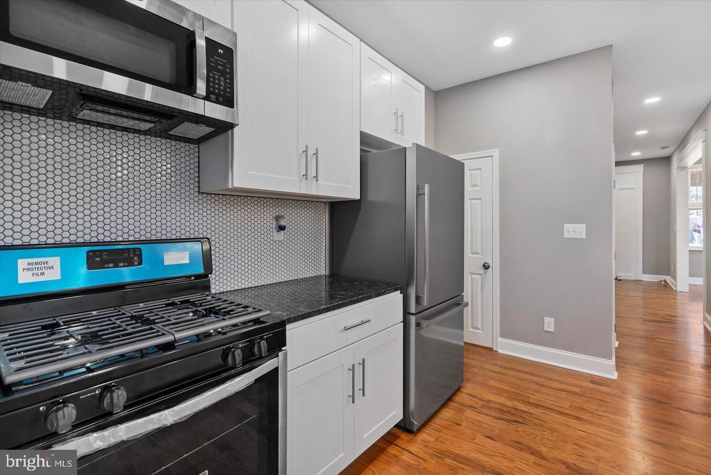 327 Lyndhurst Street Baltimore, MD 21229 - Photo 8 of 44 a kitchen with stainless steel appliances granite countertop a refrigerator and a stove
