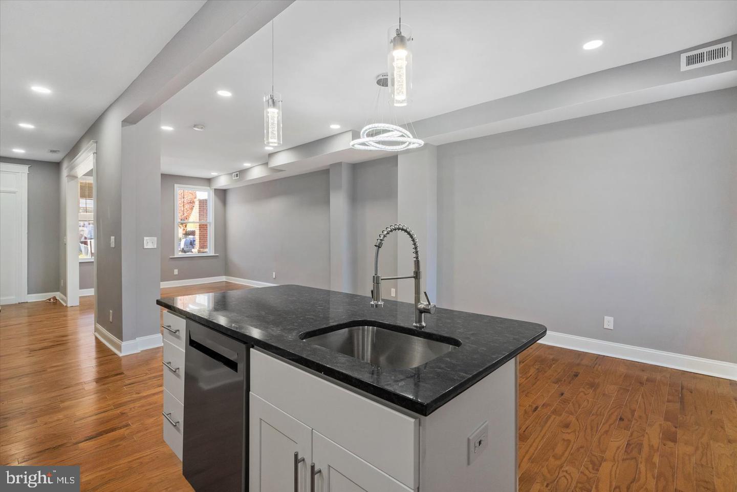 327 Lyndhurst Street Baltimore, MD 21229 - Photo 9 of 44 a kitchen with stainless steel appliances granite countertop a sink a counter space and cabinets