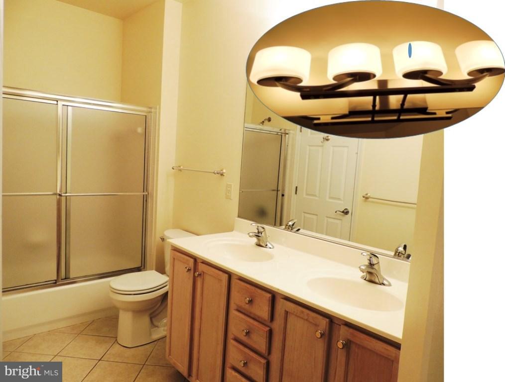 901 Spinnaker Way, Unit 901 Solomons, MD 20688 - Photo 11 of 13 a bathroom with a sink and a mirror