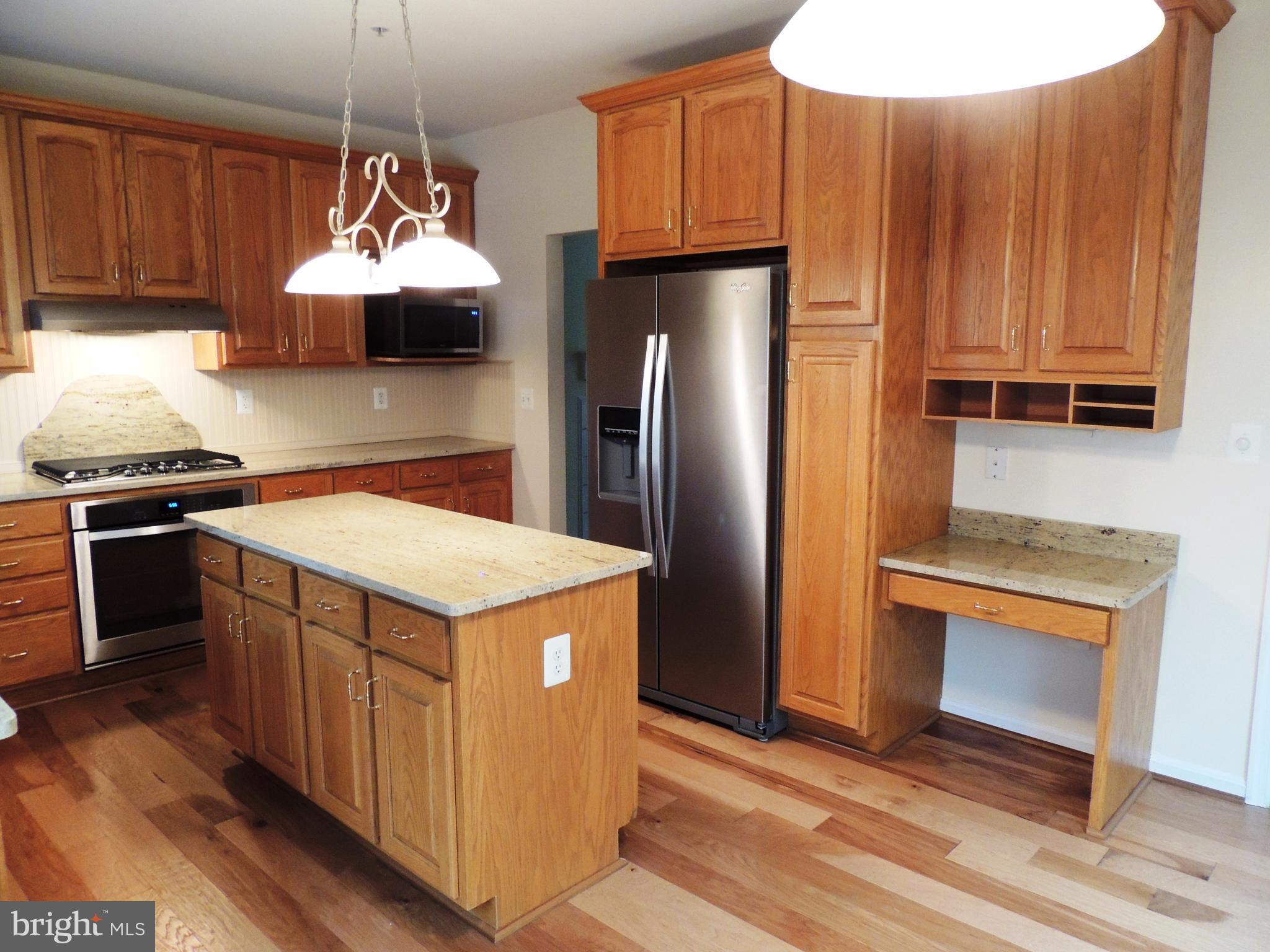 901 Spinnaker Way, Unit 901 Solomons, MD 20688 - Photo 9 of 13 a kitchen with a stove a refrigerator and a sink