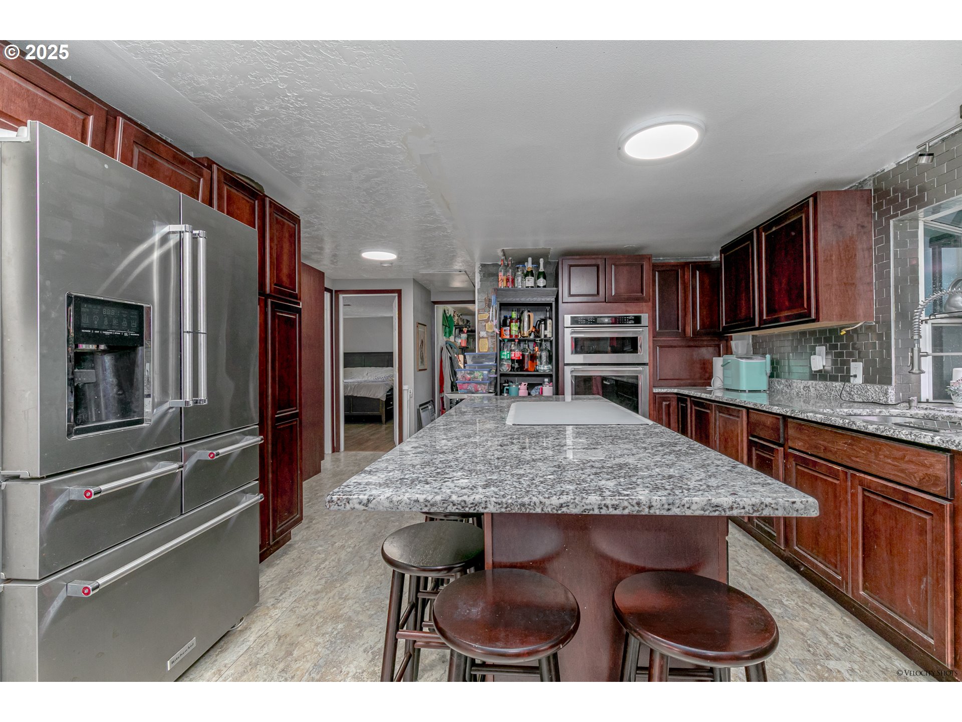 38289 Southeast Coupland Road Estacada, OR 97023 - Photo 11 of 48 a kitchen with stainless steel appliances granite countertop a sink refrigerator and cabinets