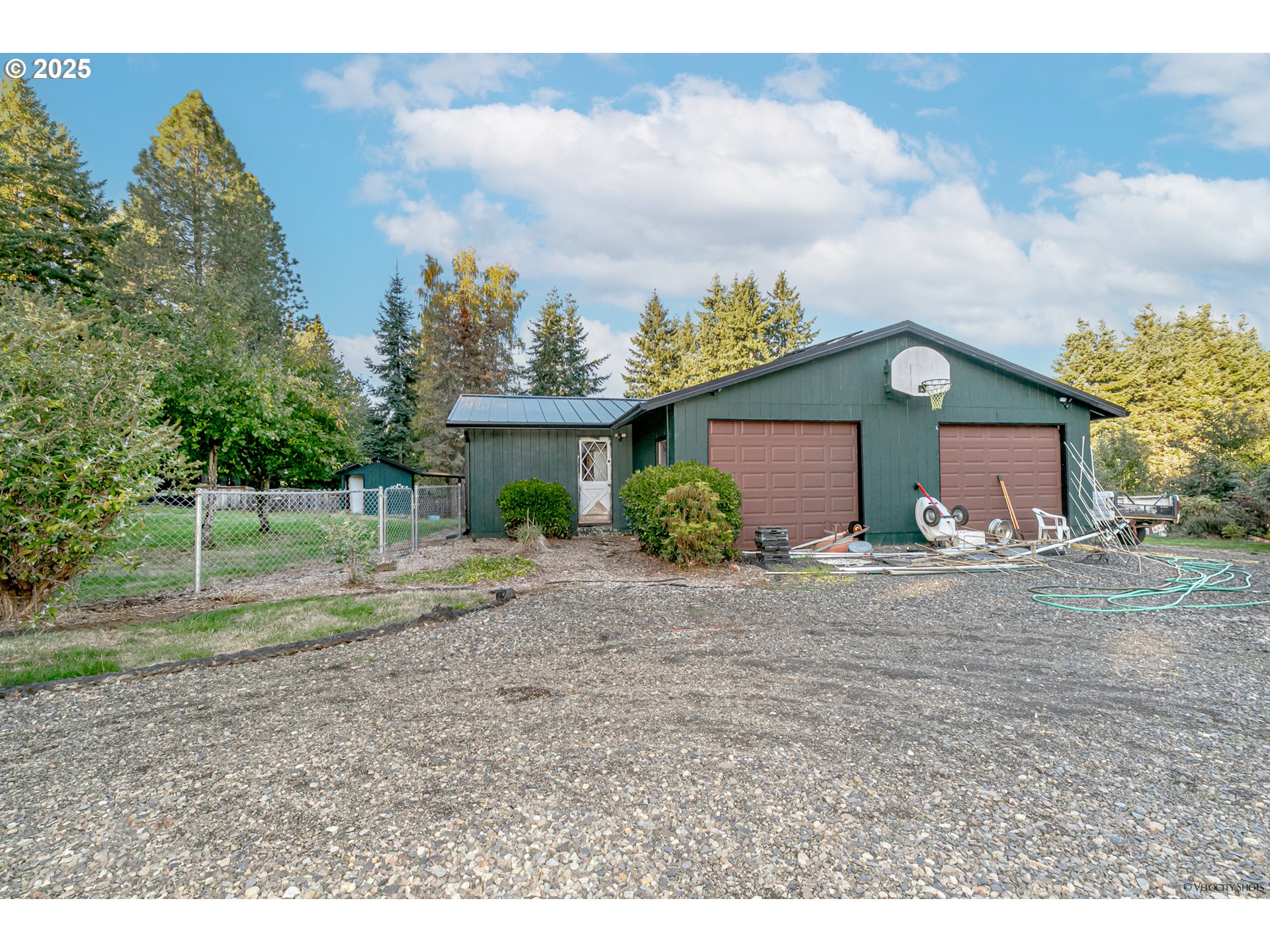 38289 Southeast Coupland Road Estacada, OR 97023 - Photo 36 of 48 a view of a house with a yard and table and chairs under an umbrella