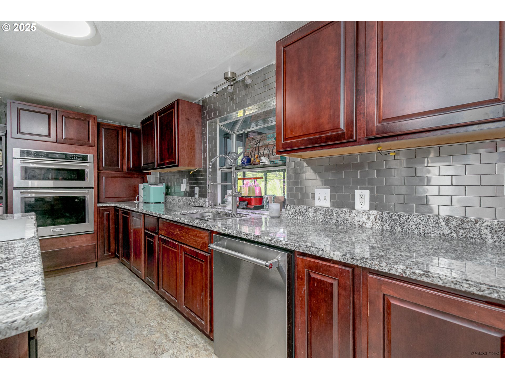 38289 Southeast Coupland Road Estacada, OR 97023 - Photo 10 of 48 a kitchen with stainless steel appliances granite countertop a sink stove and cabinets