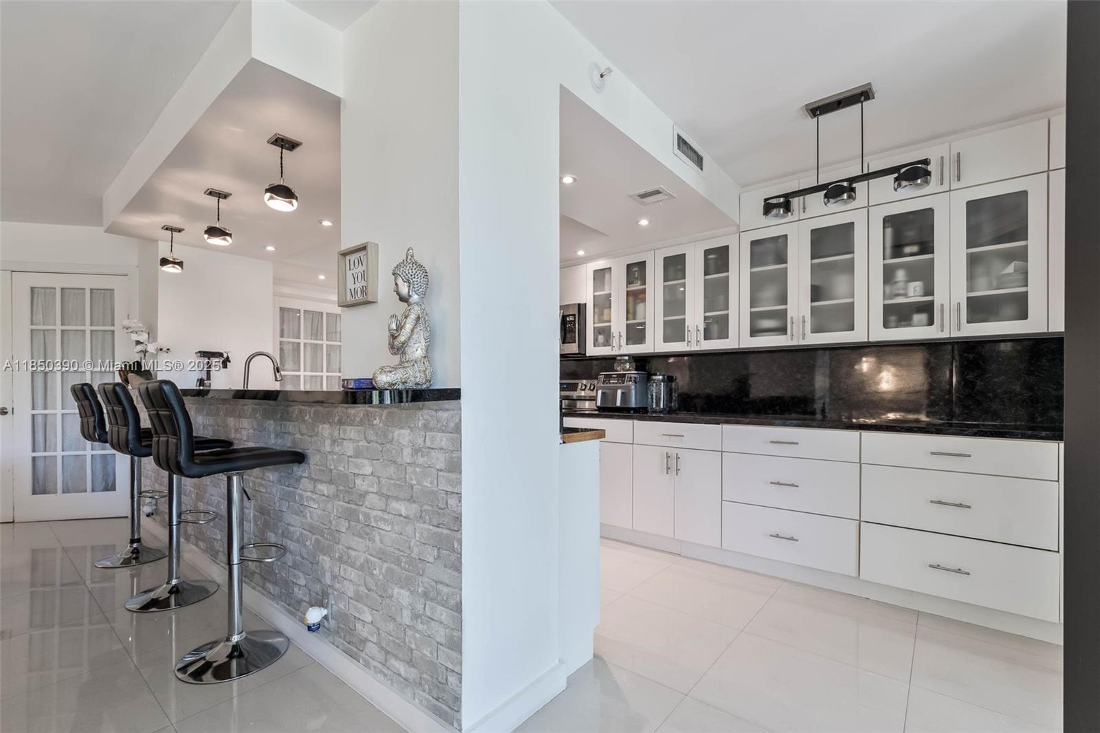 1000 Quayside Terrace, Unit 308 Miami, FL 33138 - Photo 11 of 28 a kitchen with a refrigerator and a view of living room