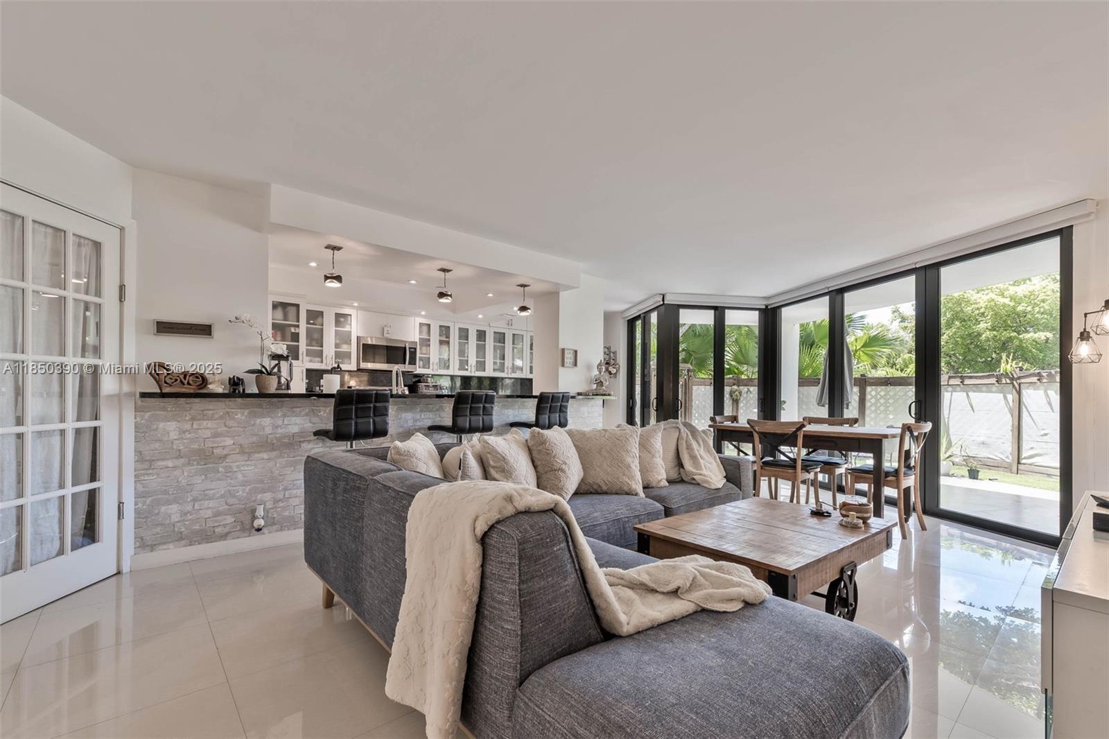 1000 Quayside Terrace, Unit 308 Miami, FL 33138 - Photo 12 of 28 a living room with furniture and large windows