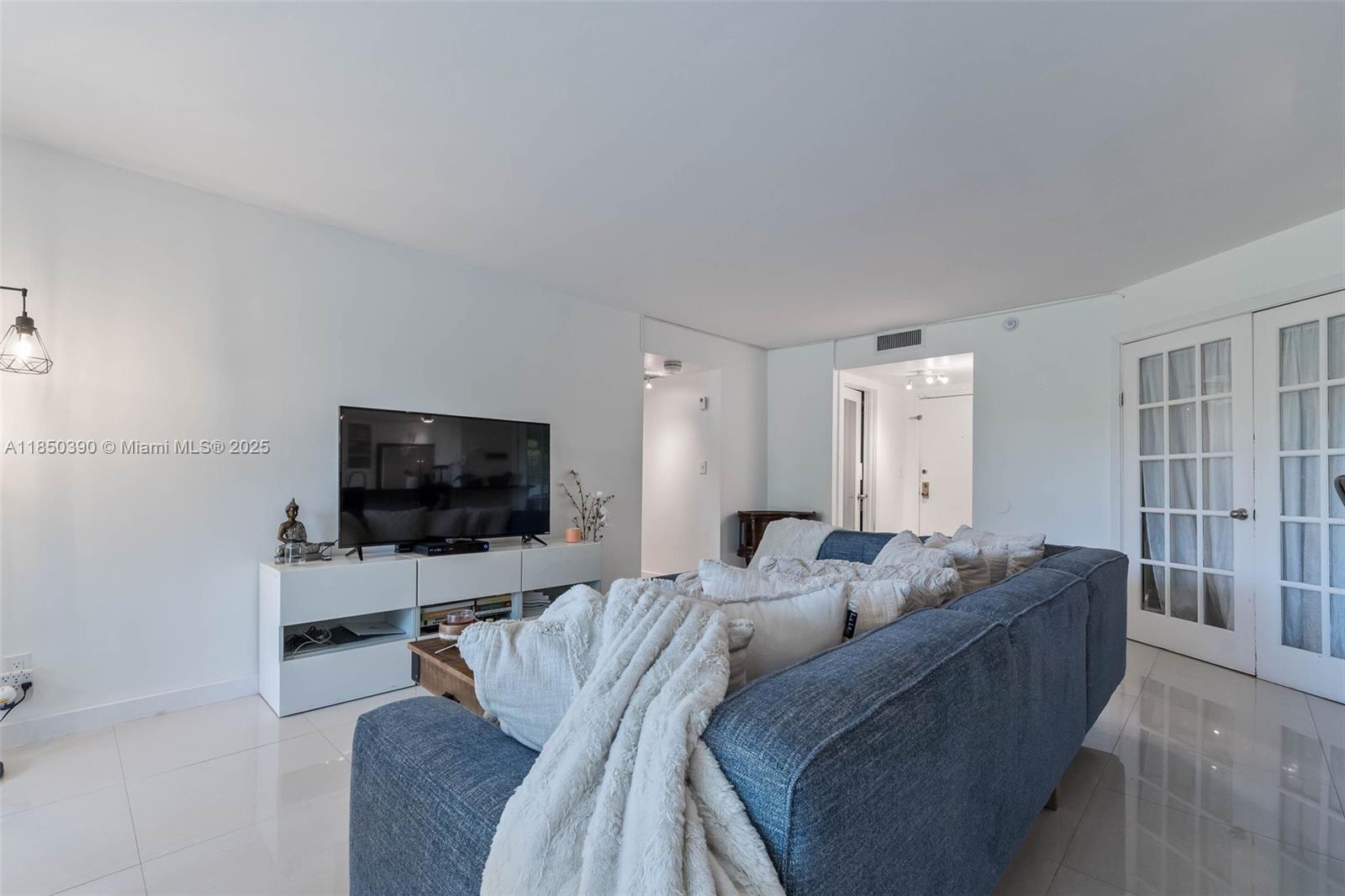 1000 Quayside Terrace, Unit 308 Miami, FL 33138 - Photo 13 of 28 a living room with furniture and a flat screen tv