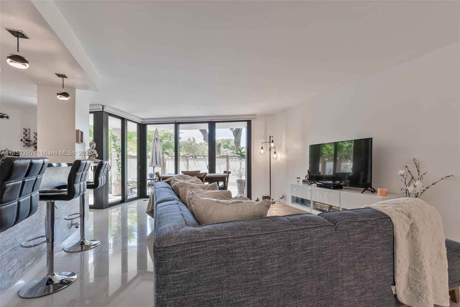 1000 Quayside Terrace, Unit 308 Miami, FL 33138 - Photo 14 of 28 a living room with furniture large window and flat screen tv