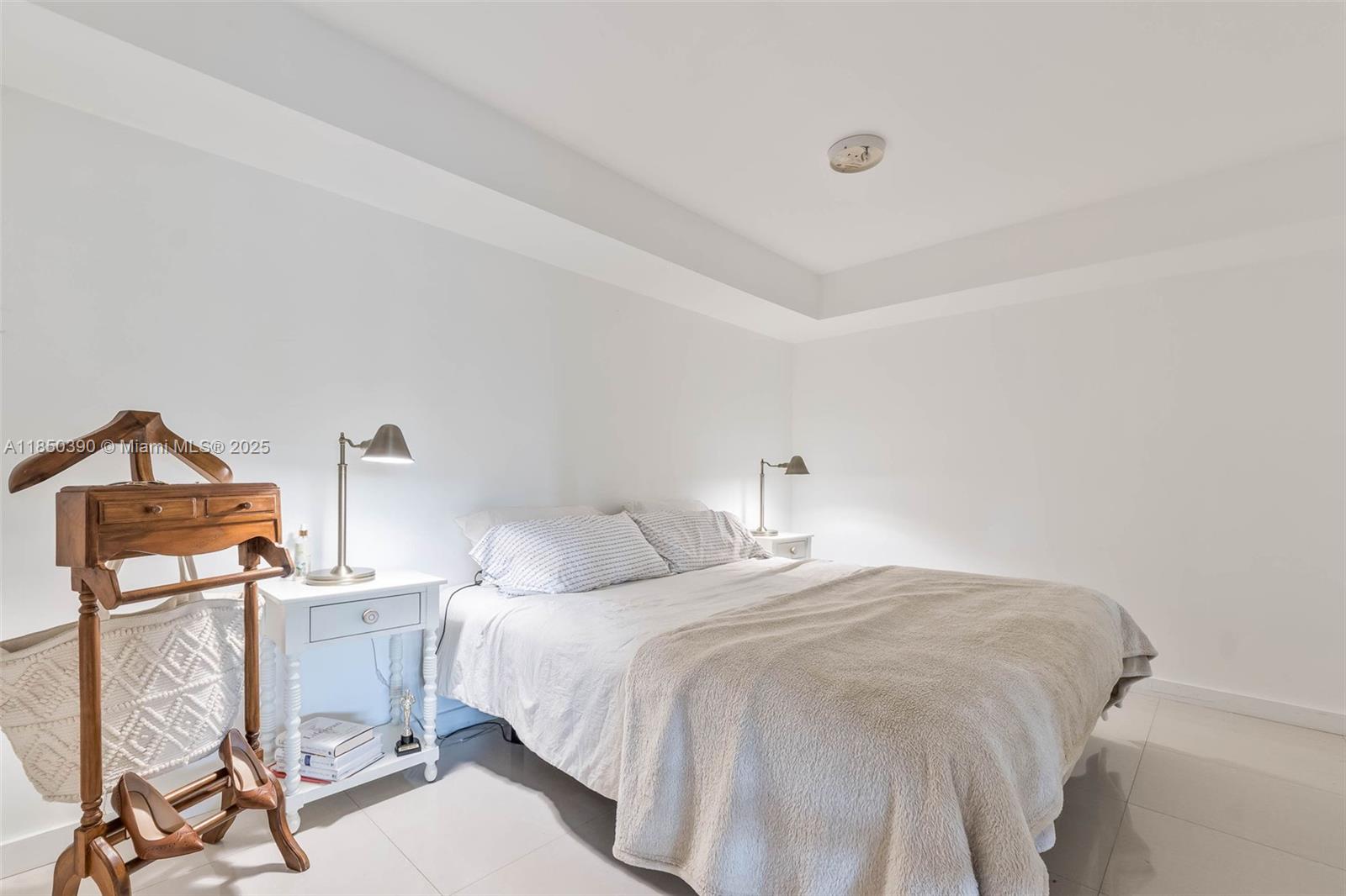 1000 Quayside Terrace, Unit 308 Miami, FL 33138 - Photo 15 of 28 a bedroom with a bed and a lamp on table