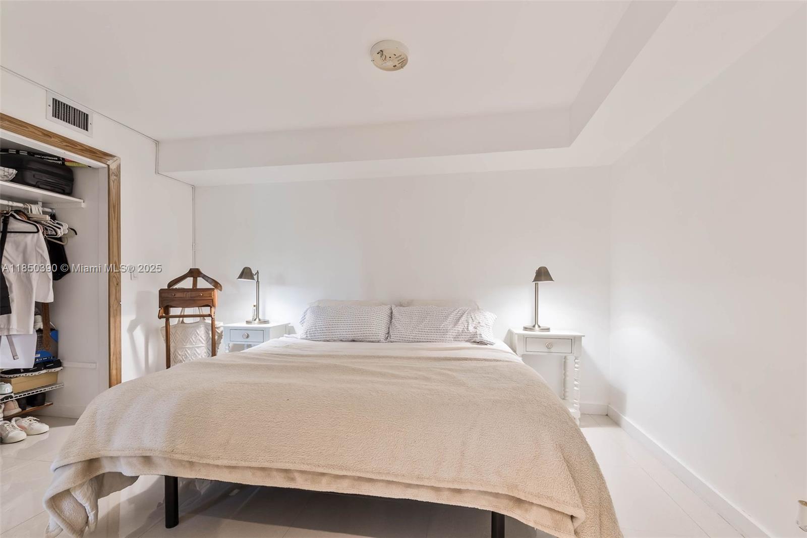 1000 Quayside Terrace, Unit 308 Miami, FL 33138 - Photo 16 of 28 a bedroom with a bed and a night stand