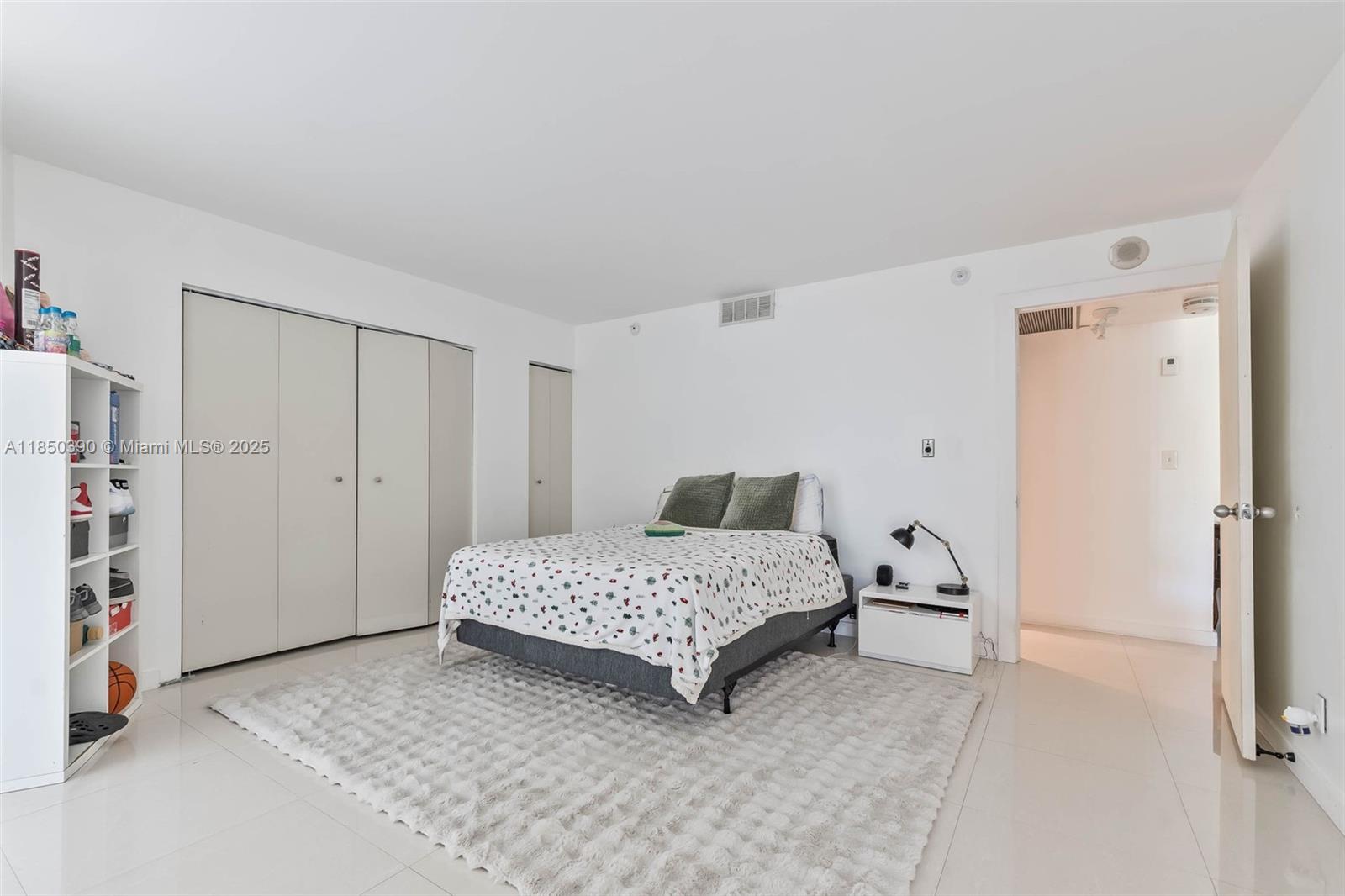 1000 Quayside Terrace, Unit 308 Miami, FL 33138 - Photo 20 of 28 a bedroom with a bed and a closet