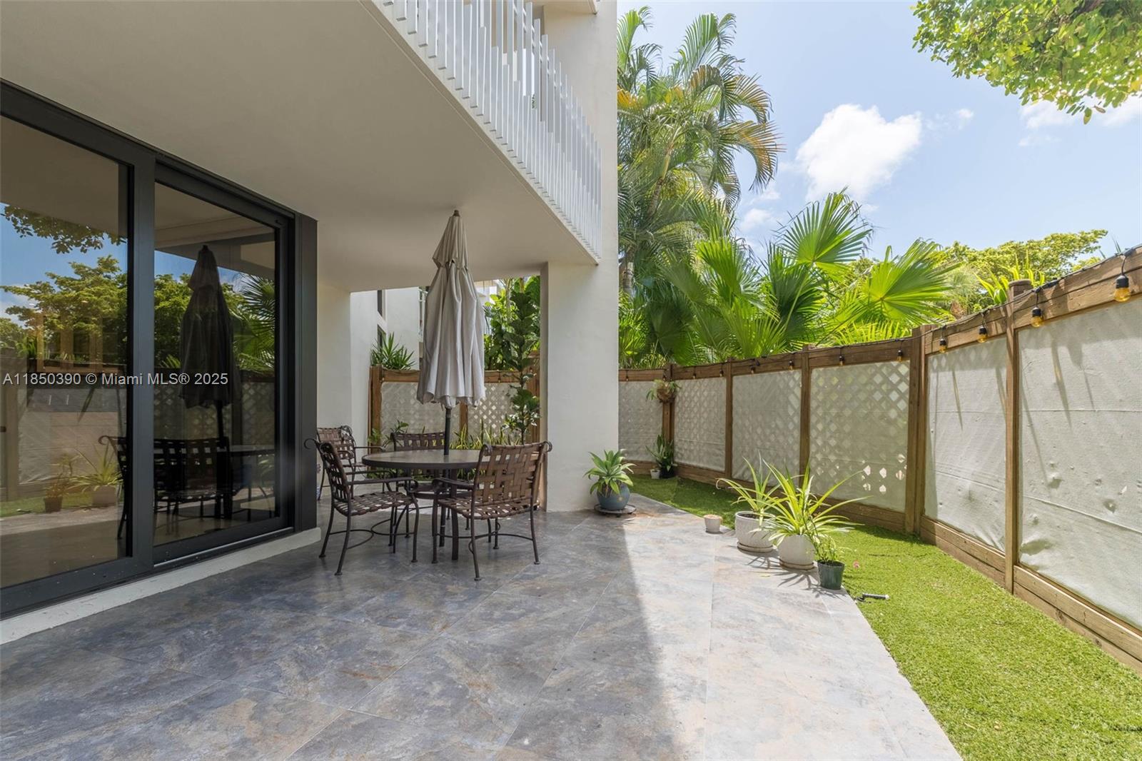 1000 Quayside Terrace, Unit 308 Miami, FL 33138 - Photo 2 of 28 a view of a patio with table and chairs and potted plants