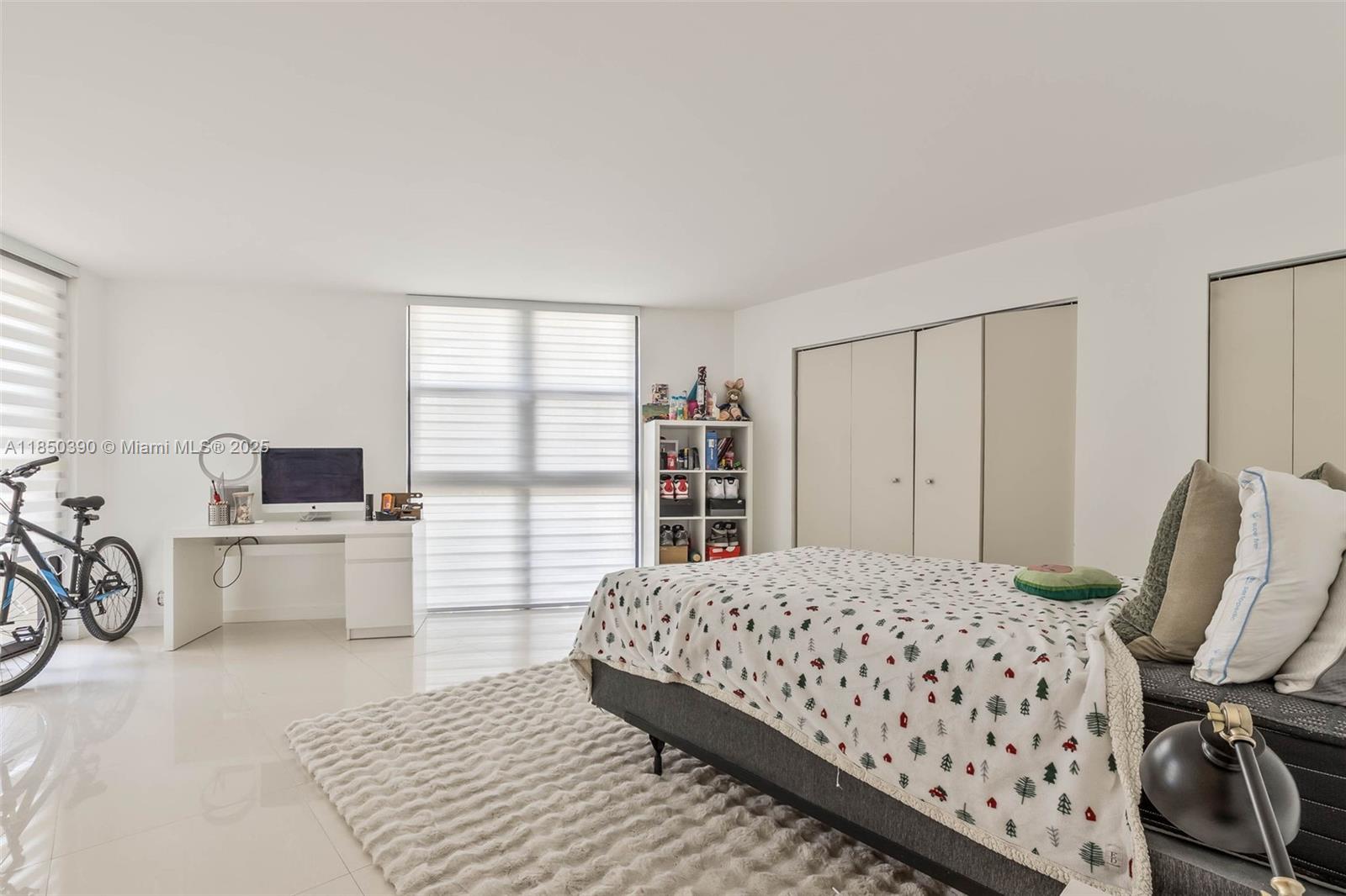 1000 Quayside Terrace, Unit 308 Miami, FL 33138 - Photo 21 of 28 a bedroom with a bed a table and chair