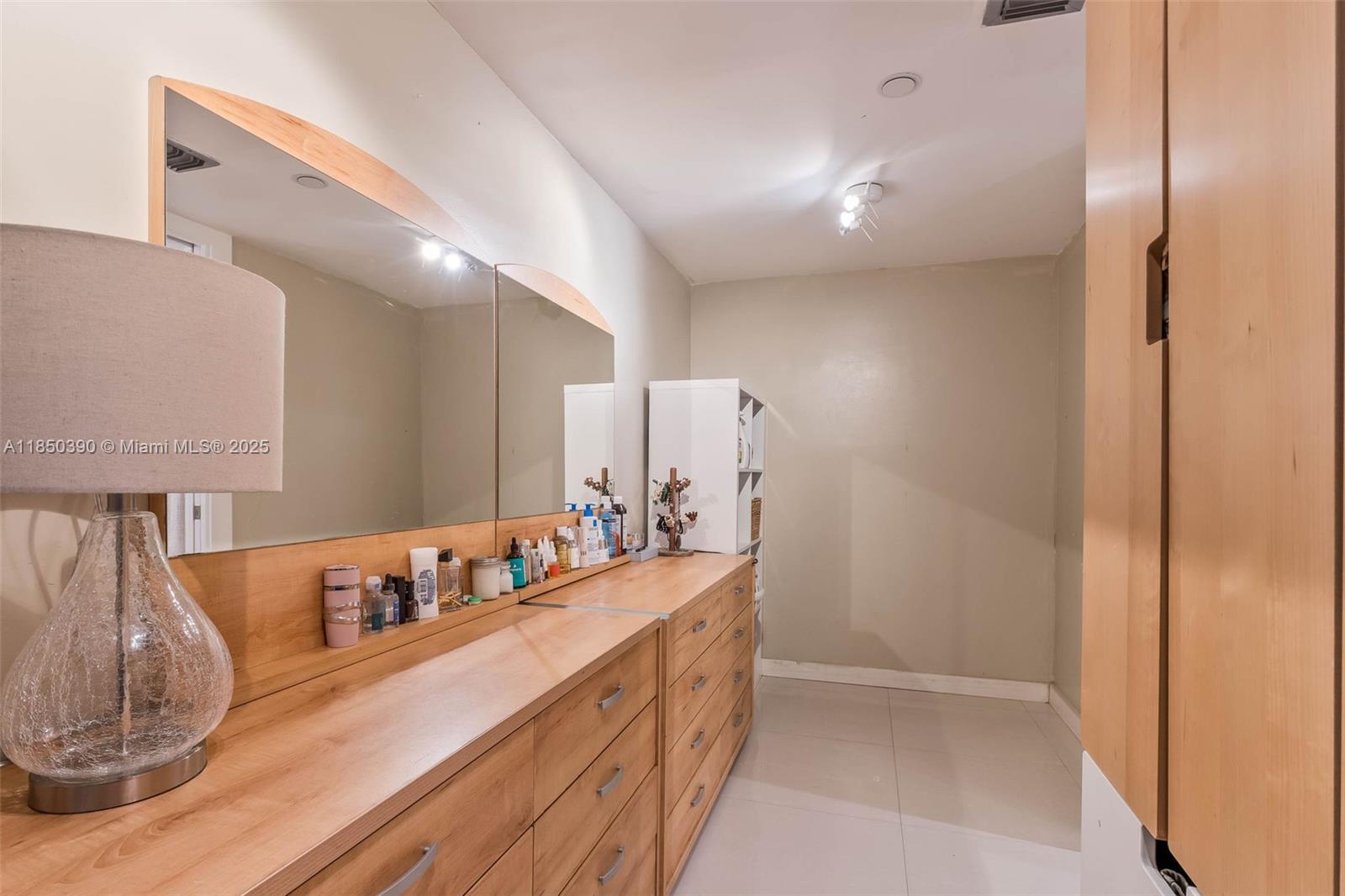 1000 Quayside Terrace, Unit 308 Miami, FL 33138 - Photo 24 of 28 a bathroom with a double vanity sink and a mirror