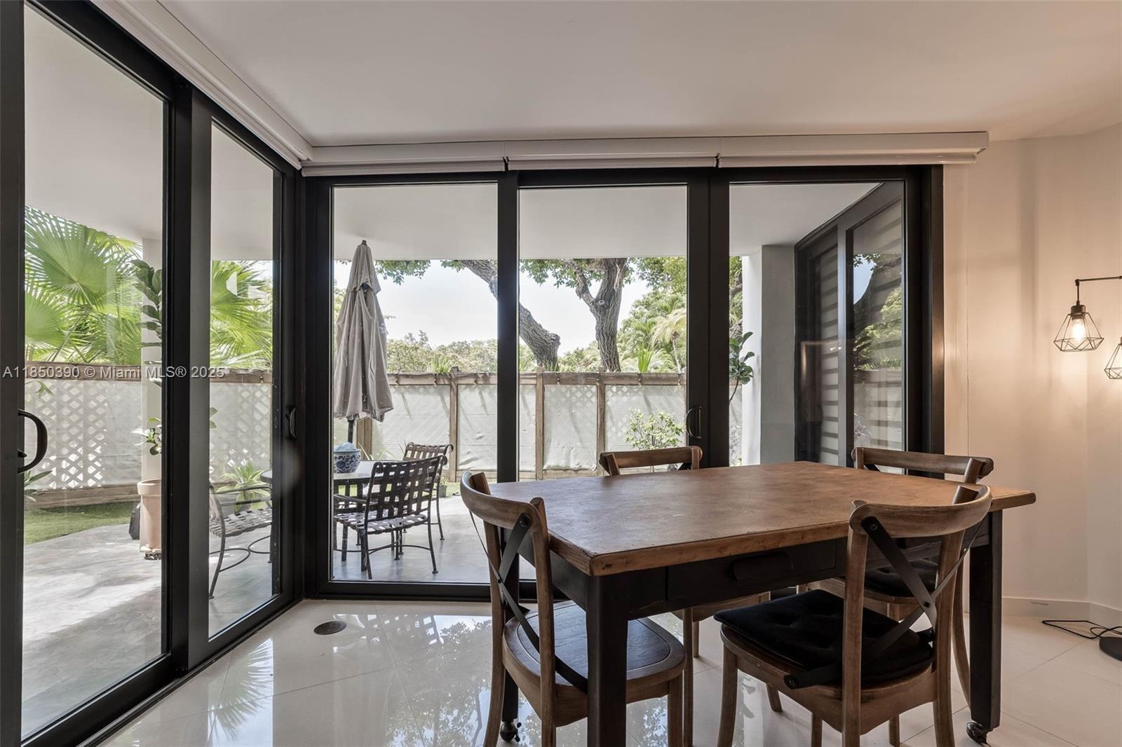 1000 Quayside Terrace, Unit 308 Miami, FL 33138 - Photo 4 of 28 a view of a dining room with furniture and window