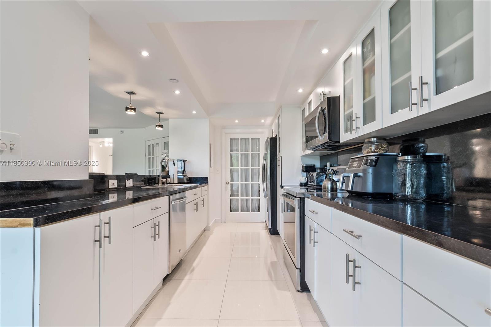 1000 Quayside Terrace, Unit 308 Miami, FL 33138 - Photo 8 of 28 a large kitchen with stainless steel appliances lots of counter space and a sink