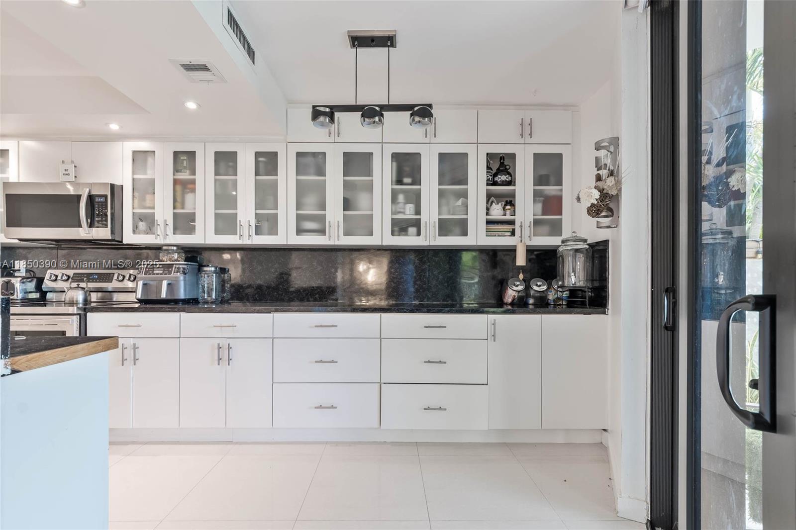 1000 Quayside Terrace, Unit 308 Miami, FL 33138 - Photo 10 of 28 a kitchen with stainless steel appliances granite countertop a refrigerator and a stove top oven