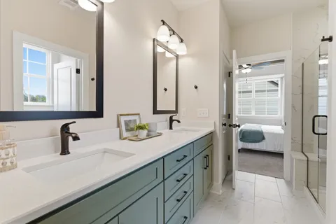 a en suite bathroom with double sink and a mirror