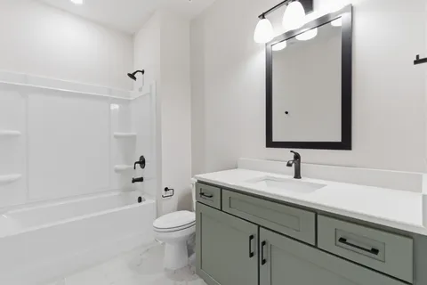 a bathroom with a sink a toilet and a mirror