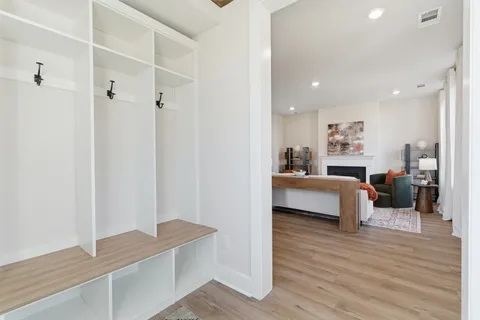 a living room with furniture and a wooden floor