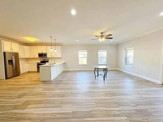 a view of kitchen with cabinets and wooden floor