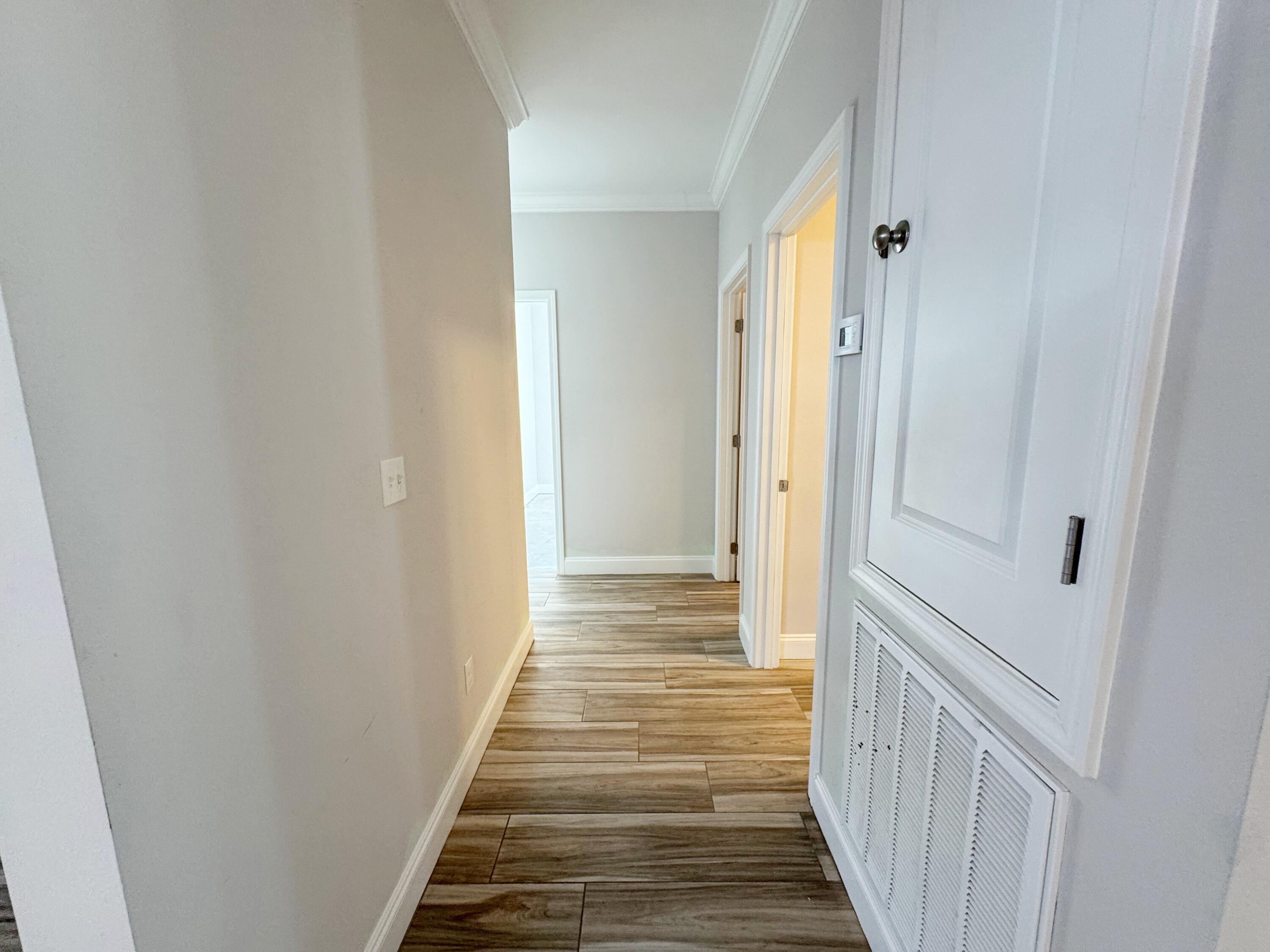 420 Little John Road Mary Esther, FL 32569 - Photo 15 of 37 a view of a hallway with wooden floor and staircase