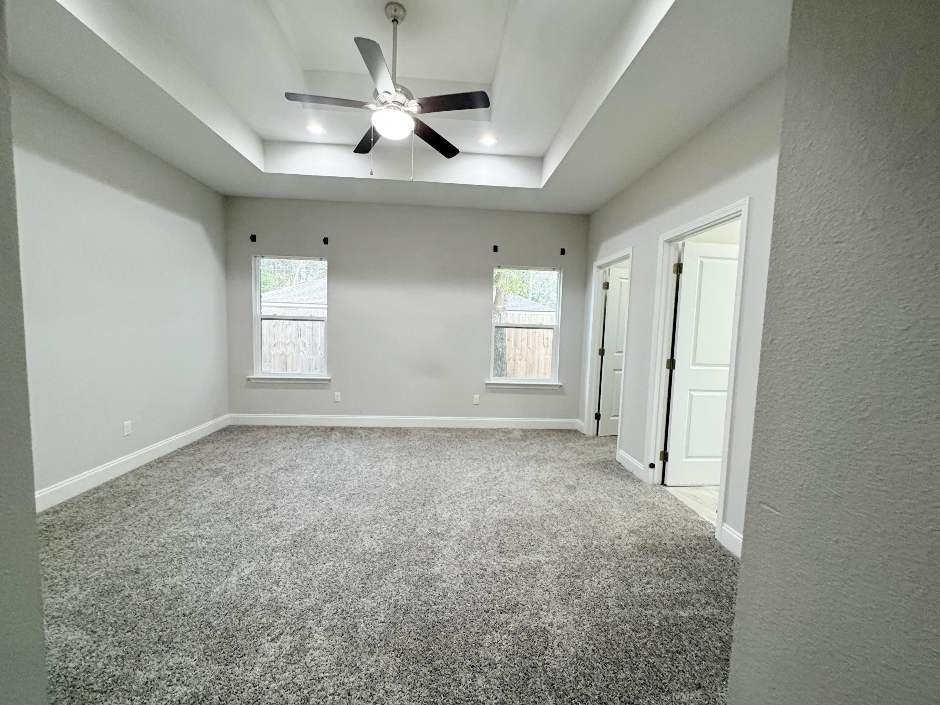 420 Little John Road Mary Esther, FL 32569 - Photo 16 of 37 en empty room with windows and ceiling fan