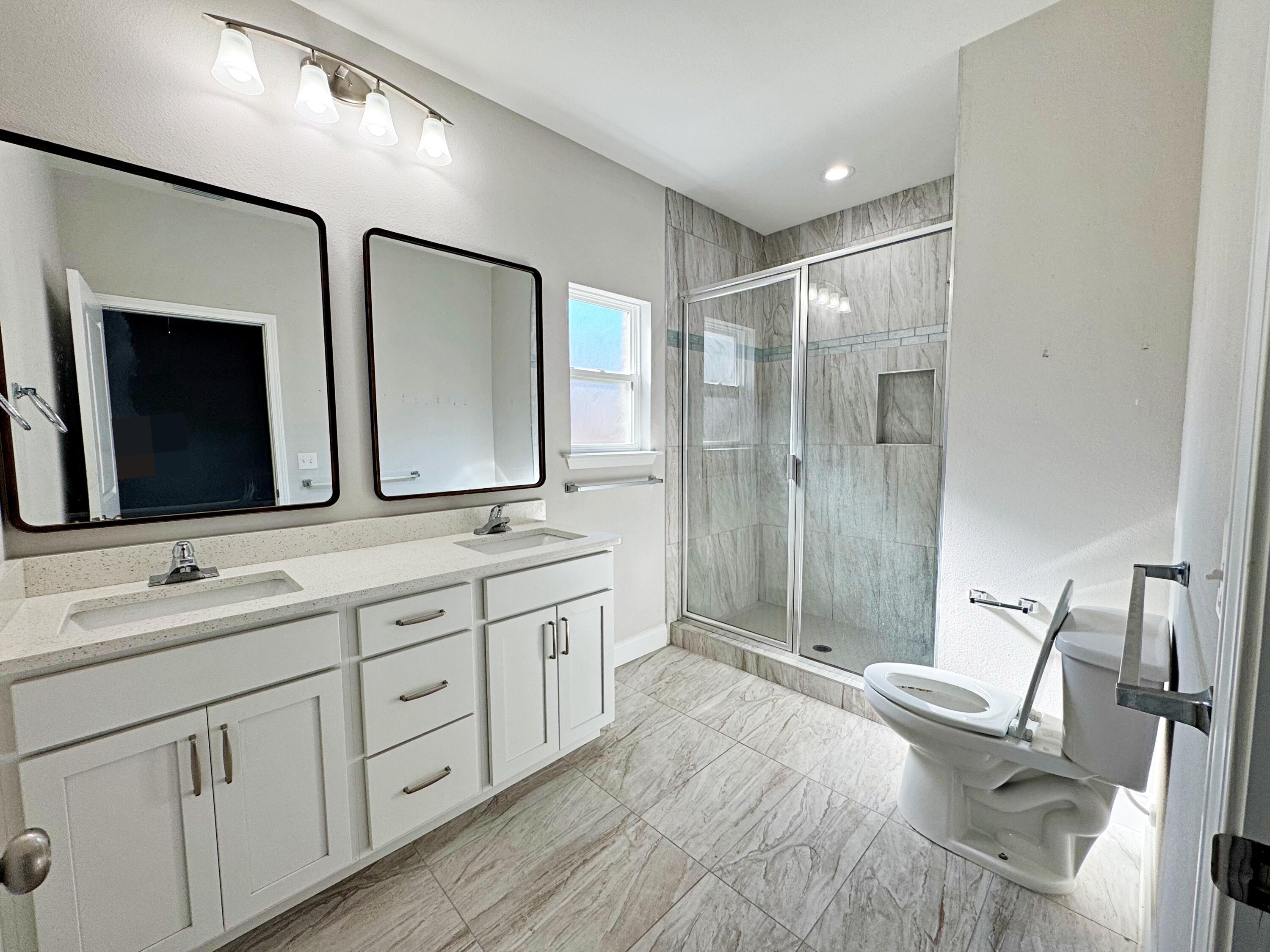 420 Little John Road Mary Esther, FL 32569 - Photo 21 of 37 a spacious bathroom with a double vanity sink mirror and double