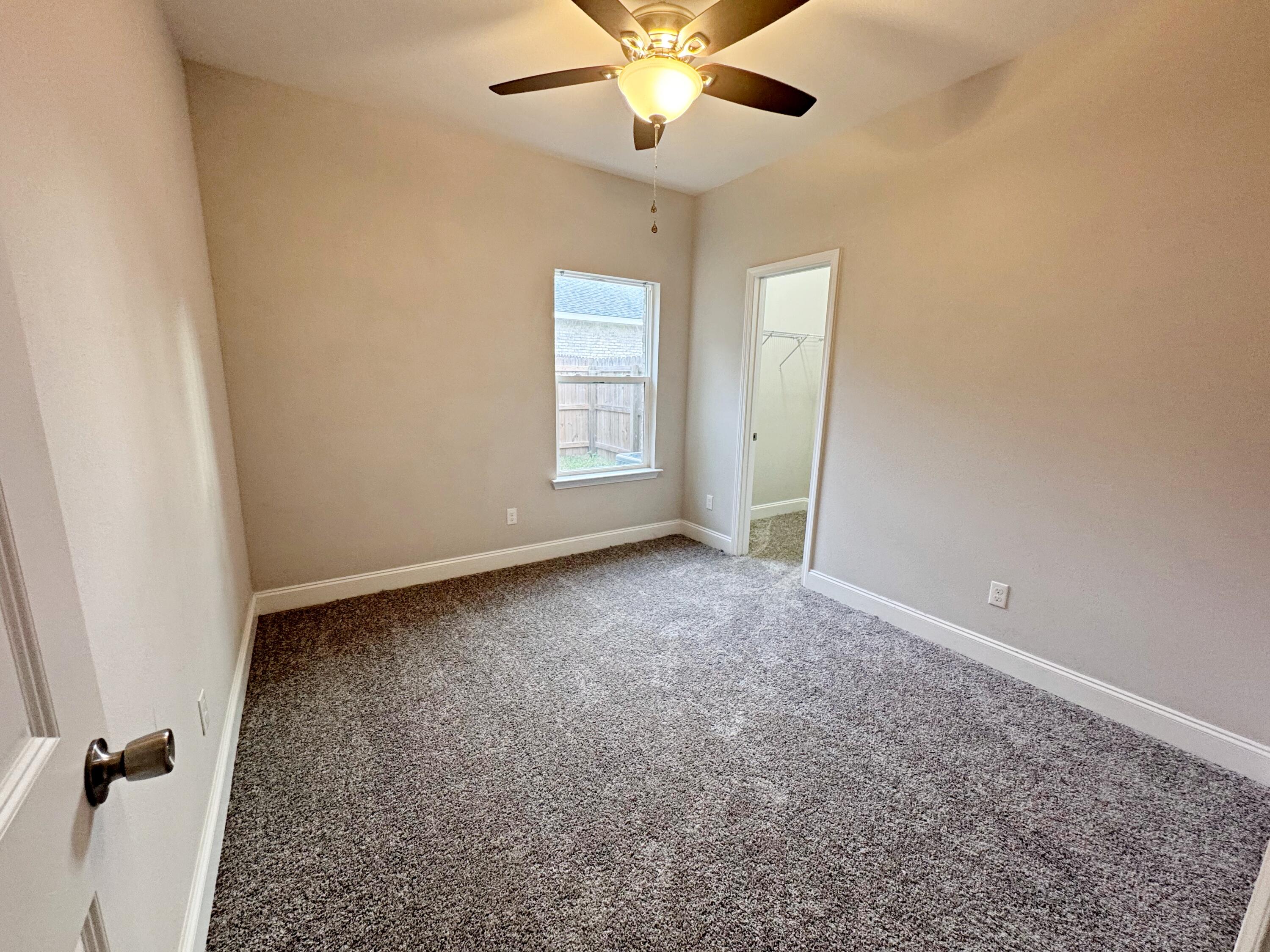 420 Little John Road Mary Esther, FL 32569 - Photo 25 of 37 an empty room with windows and fan