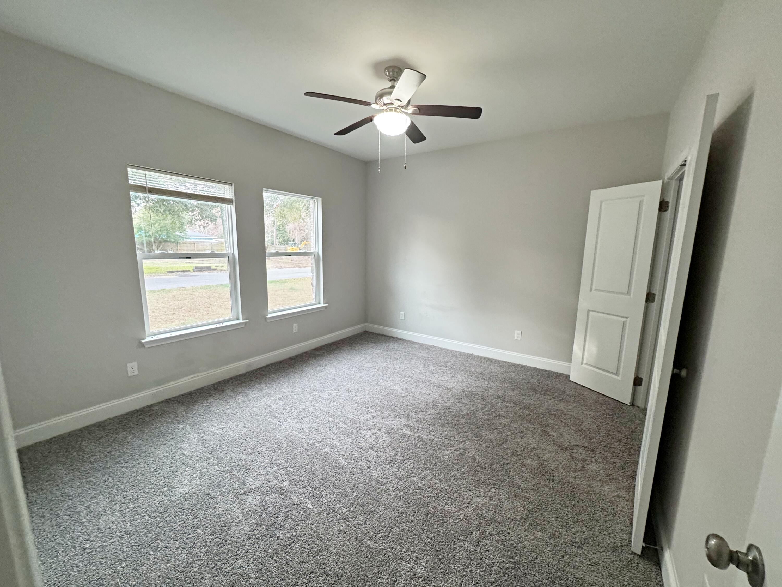 420 Little John Road Mary Esther, FL 32569 - Photo 27 of 37 an empty room with windows and fan