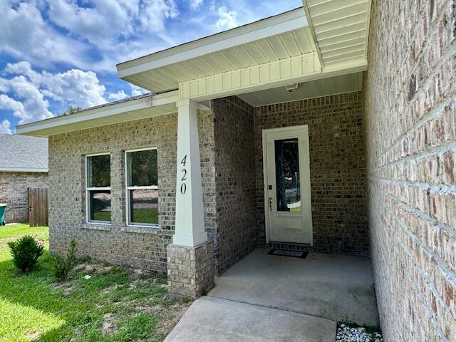 420 Little John Road Mary Esther, FL 32569 - Photo 3 of 37 a front view of a house with a garden