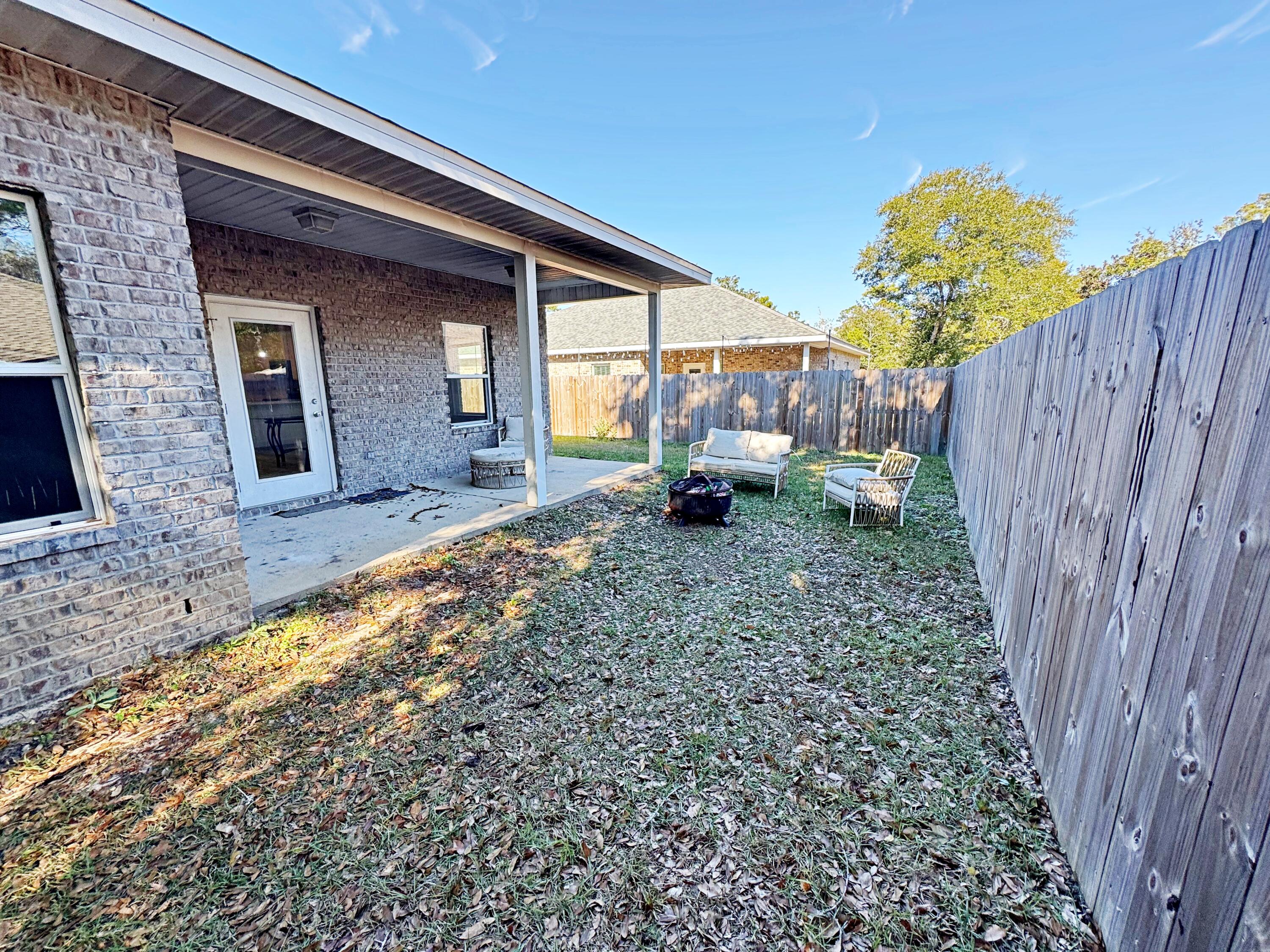 420 Little John Road Mary Esther, FL 32569 - Photo 35 of 37 a view of backyard of house with wooden fence