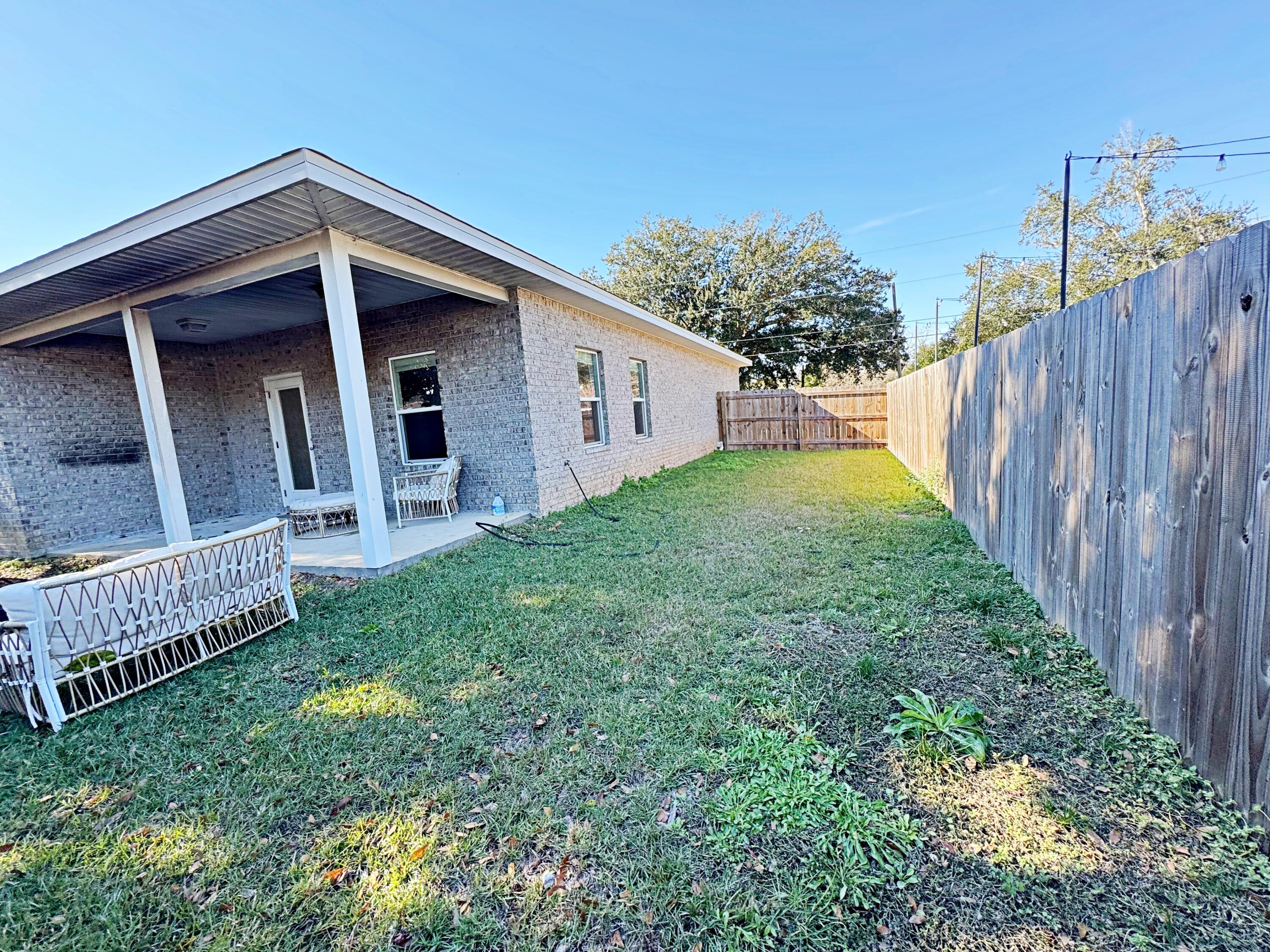 420 Little John Road Mary Esther, FL 32569 - Photo 36 of 37 a view of backyard of house with wooden fence