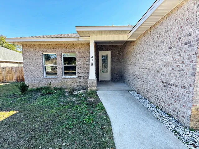a view of house with backyard