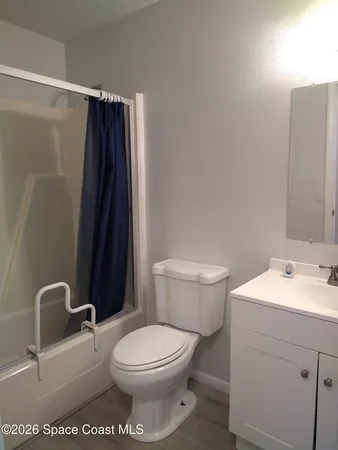 a white toilet sitting next to a bathroom sink