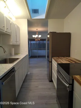 a kitchen with stainless steel appliances granite countertop a sink and a stove