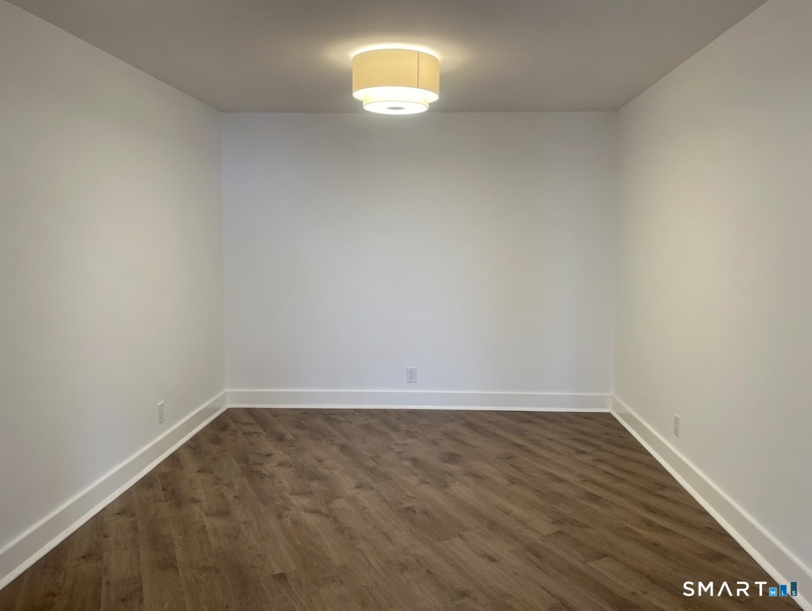 25 Forest Street, Unit 7K Stamford, CT 06901 - Photo 4 of 15 wooden floor in an empty room