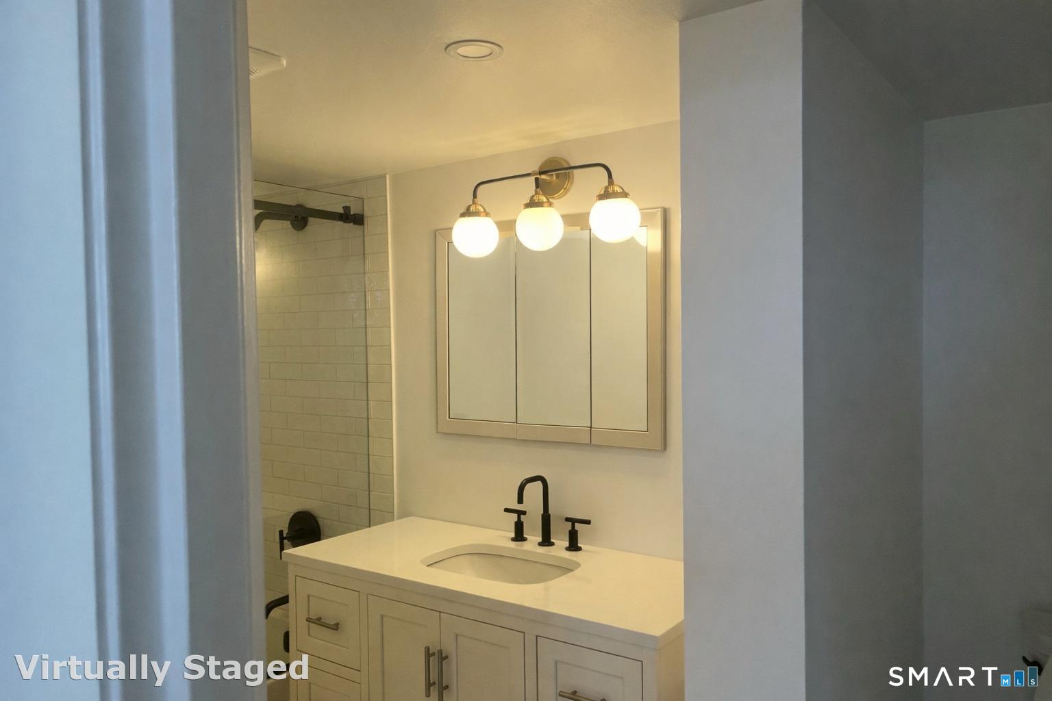 25 Forest Street, Unit 7K Stamford, CT 06901 - Photo 7 of 15 a bathroom with a sink and a mirror