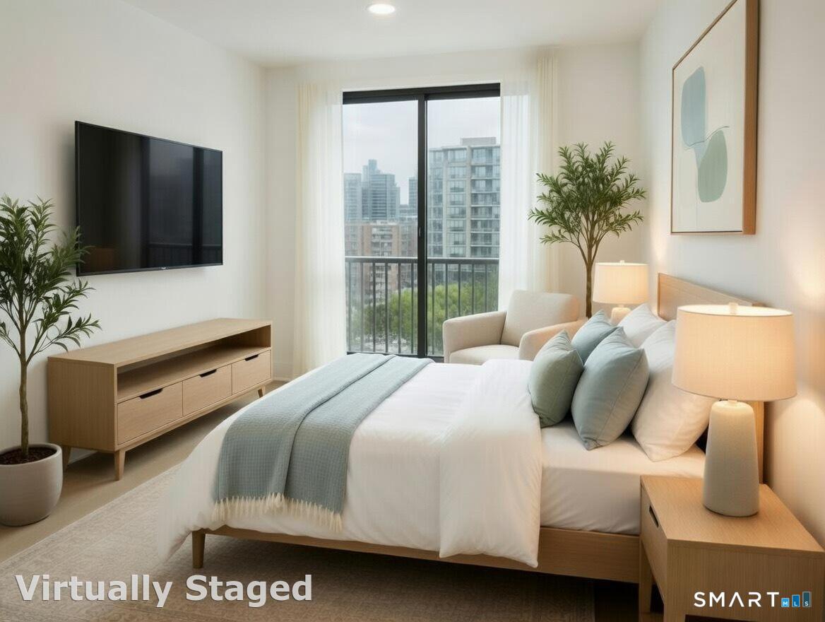 25 Forest Street, Unit 7K Stamford, CT 06901 - Photo 8 of 15 a bedroom with a large bed and a flat tv screen on dresser