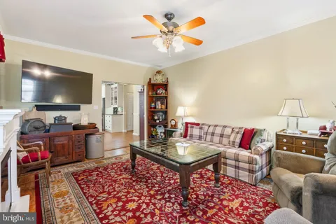 a front view of a house with garden and trees