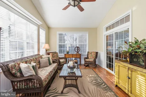 a view of a house with a yard and sitting area