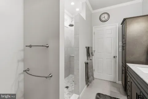 a front view of a house with a yard and potted plants