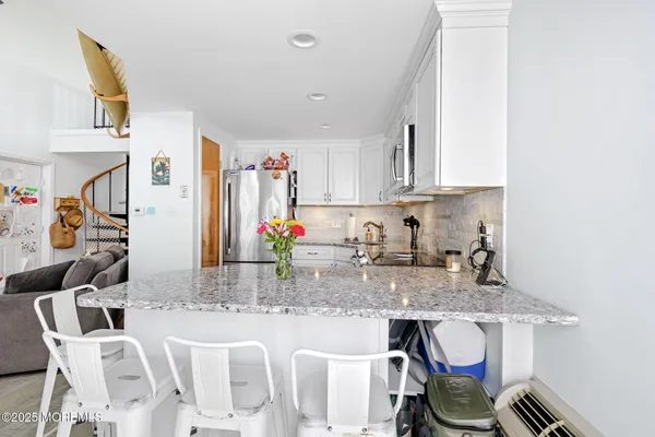 a kitchen with stainless steel appliances granite countertop a refrigerator stove and microwave